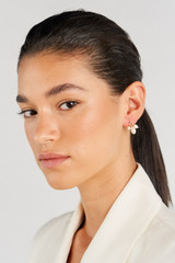 Profile view of model wearing the Oroton Kimberley Pearl Charm Stud Earrings in Gold/Pearl and Brass for Women