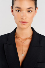 Profile view of model wearing the Oroton Kimberley Pearl Lariat Necklace in Gold/Pearl and Brass for Women