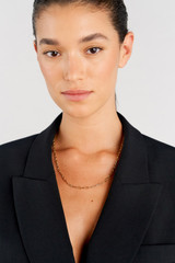 Profile view of model wearing the Oroton Kimberley Pearl Lariat Necklace in Gold/Pearl and Brass for Women