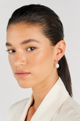 Profile view of model wearing the Oroton Kimberley Pearl Drop Hook Earrings in Gold/Pearl and Brass for Women