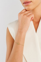 Profile view of model wearing the Oroton Leah Chain Bracelet in Gold and Stainless Steel for Women