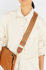 Profile view of model wearing the Oroton Heather Long Webbing Strap in Tan/Cognac and 100% Jacqard webbing for Women