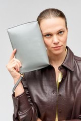 Profile view of model wearing the Oroton Mia Pouch in Grey Flannel and Smooth leather for Women