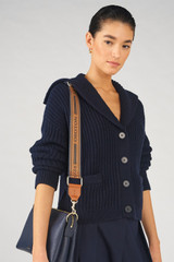 Profile view of model wearing the Oroton Heather Long Webbing Strap in Navy/Cognac and 100% Jacqard webbing for Women