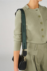Profile view of model wearing the Oroton Heather Long Webbing Strap in Juniper/Black and 100% Jacqard webbing for Women