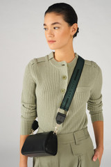 Profile view of model wearing the Oroton Heather Long Webbing Strap in Juniper/Black and 100% Jacqard webbing for Women