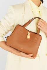 Profile view of model wearing the Oroton Tate Small Three Pocket Day Bag in Brandy and Pebble leather for Women