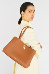 Profile view of model wearing the Oroton Tate Three Pocket Day Bag in Brandy and Pebble leather for Women