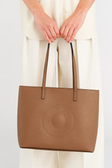Profile view of model wearing the Oroton Polly Medium Zip Tote in Tan and Pebble Leather for Women
