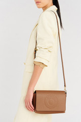 Profile view of model wearing the Oroton Polly Crossbody in Tan and Pebble leather for Women