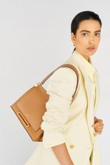 Profile view of model wearing the Oroton Elm Medium Satchel Bag in Tan and Smooth Pebble Leather for Women