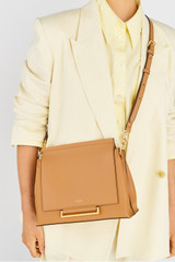 Profile view of model wearing the Oroton Elm Medium Satchel Bag in Tan and Smooth Pebble Leather for Women