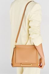 Profile view of model wearing the Oroton Elm Medium Satchel Bag in Tan and Smooth Pebble Leather for Women