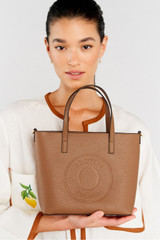 Profile view of model wearing the Oroton Polly Small Tote in Tan and Pebble Leather for Women