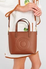 Profile view of model wearing the Oroton Polly Smooth Small Tote in Cognac and Smooth leather fused with saffiano PU for Women