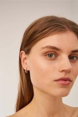 Profile view of model wearing the Oroton Lacey Small Hoops in Silver and Brass for Women