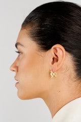 Profile view of model wearing the Oroton Leah Hoop Earrings in Gold and Stainless Steel for Women