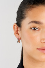 Profile view of model wearing the Oroton Leah Hoop Earrings in Silver and Stainless Steel for Women