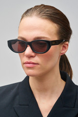 Profile view of model wearing the Oroton Nadja Sunglasses in Black and Bio acetate (Biodegradeable) for Women