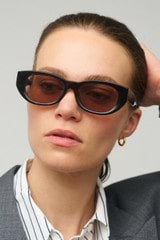 Profile view of model wearing the Oroton Nadja Sunglasses in Signature Tort and Bio acetate (Biodegradeable) for Women