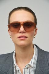 Profile view of model wearing the Oroton Rupea Sunglasses in Amber and Acetate for Women