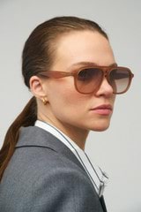 Profile view of model wearing the Oroton Rupea Sunglasses in Amber and Acetate for Women