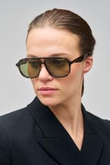 Profile view of model wearing the Oroton Rupea Sunglasses in Neo Tort and Bio acetate (Biodegradeable) for Women