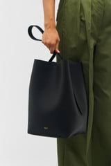 Profile view of model wearing the Oroton Ellis Hobo in Black and Pebble leather for Women