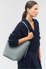 Profile view of model wearing the Oroton Ellis Hobo in Grey Flannel and Pebble leather for Women