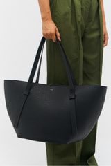 Profile view of model wearing the Oroton Ellis Medium Tote in Black and Pebble leather for Women