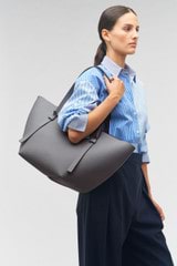 Profile view of model wearing the Oroton Ellis Medium Tote in Grey Flannel and Pebble leather for Women