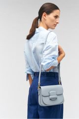 Profile view of model wearing the Oroton Carter Small Day Bag in Dusk Blue and Smooth leather for Women