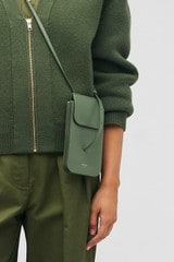 Profile view of model wearing the Oroton Margot Phone Crossbody in Moss and Pebble leather for Women