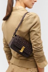 Profile view of model wearing the Oroton Etta Collectable Crossbody in Mahogany and Smooth leather for Women