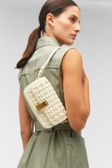 Profile view of model wearing the Oroton Etta Collectable Crossbody in Custard and Smooth leather for Women
