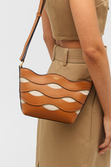 Profile view of model wearing the Oroton Leigh Ric Rac Crossbody in Amber and Smooth leather for Women
