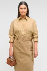 Profile view of model wearing the Oroton Poplin Long Sleeve Shirt in Camel and 100% cotton for Women