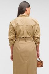 Profile view of model wearing the Oroton Poplin Long Sleeve Shirt in Camel and 100% cotton for Women