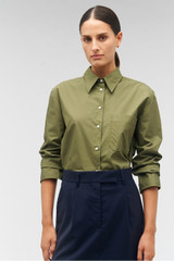 Profile view of model wearing the Oroton Poplin Long Sleeve Shirt in Green Olive and 100% cotton for Women