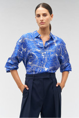 Profile view of model wearing the Oroton Long Sleeve Map Print Camp Shirt in Indigo and 100% silk for Women