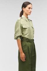 Profile view of model wearing the Oroton Military Silk Shirt in Sage and 100% silk for Women