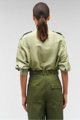 Profile view of model wearing the Oroton Military Silk Shirt in Sage and 100% silk for Women