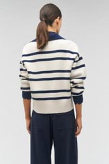 Profile view of model wearing the Oroton Stripe Polo in North Sea/Cream and 100% wool for Women