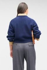 Profile view of model wearing the Oroton Crop Crew Sweater in North Sea and 100% wool for Women