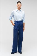 Profile view of model wearing the Oroton Tab Detail Pant in Workwear Blue and 77% cotton, 23% linen for Women