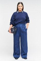 Profile view of model wearing the Oroton Tab Detail Pant in Workwear Blue and 77% cotton, 23% linen for Women