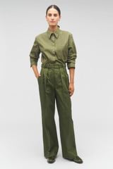 Profile view of model wearing the Oroton Tab Detail Pant in Green Olive and 77% cotton, 23% linen for Women