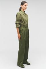 Profile view of model wearing the Oroton Tab Detail Pant in Green Olive and 77% cotton, 23% linen for Women
