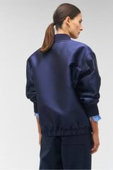 Profile view of model wearing the Oroton Longline Bomber in North Sea and 85% polyester, 15% silk for Women