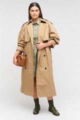 Profile view of model wearing the Oroton Trench in Dark Camel and 65% polyester, 35% cotton for Women